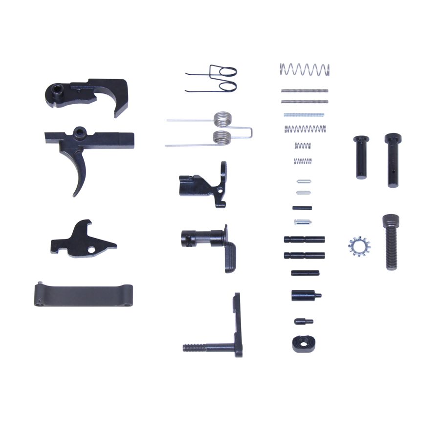 AR-platform rifle lower parts kit display with trigger assembly, springs, pins, and fasteners.