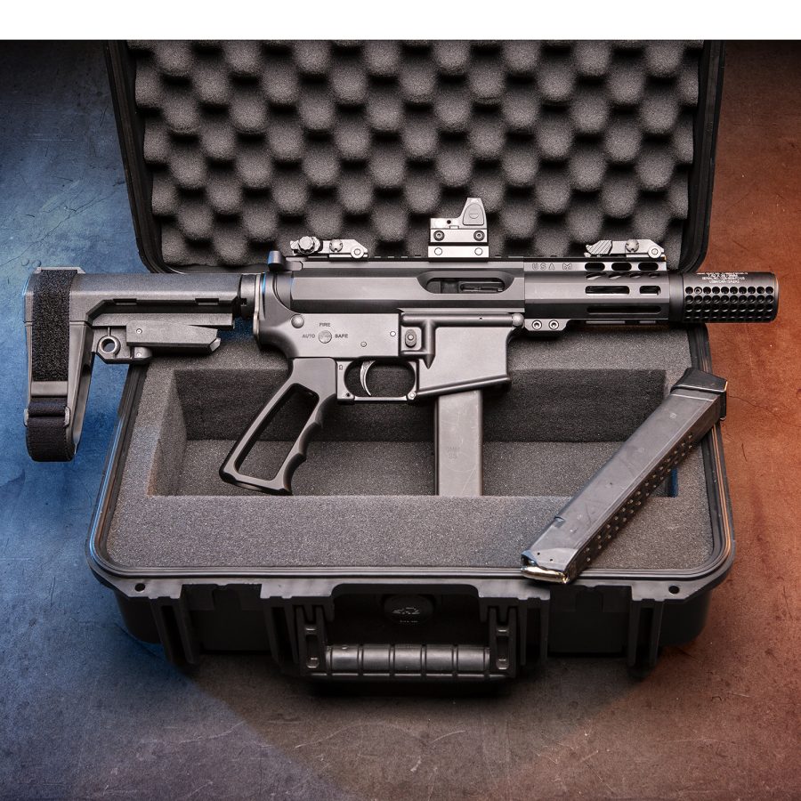 Compact tactical firearm with red dot sight in custom waterproof case.