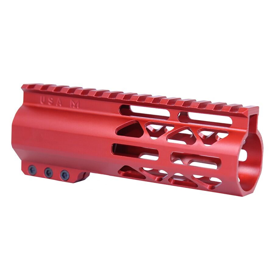 Red anodized firearm handguard with Picatinny rail, geometric cutouts, and USA M engraving.