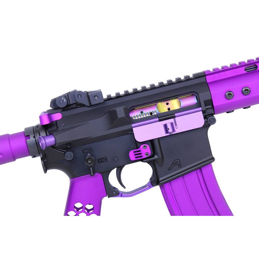 Close-up of a custom purple and black tactical AR rifle with gold bolt carrier.