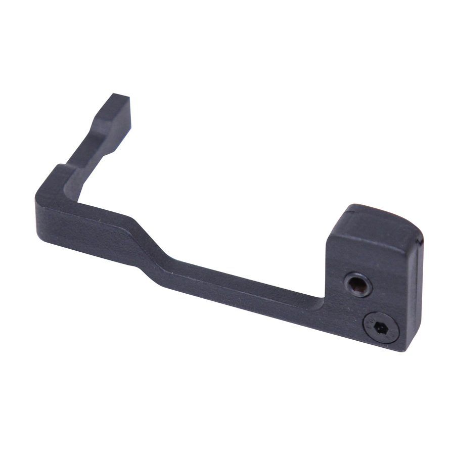 L-shaped black metal component, CNC machined, possibly a trigger guard with mounting ports.