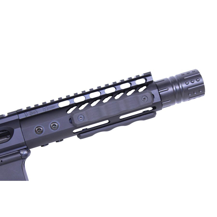 Close-up of modular tactical rifle handguard with Picatinny rails and flash hider.