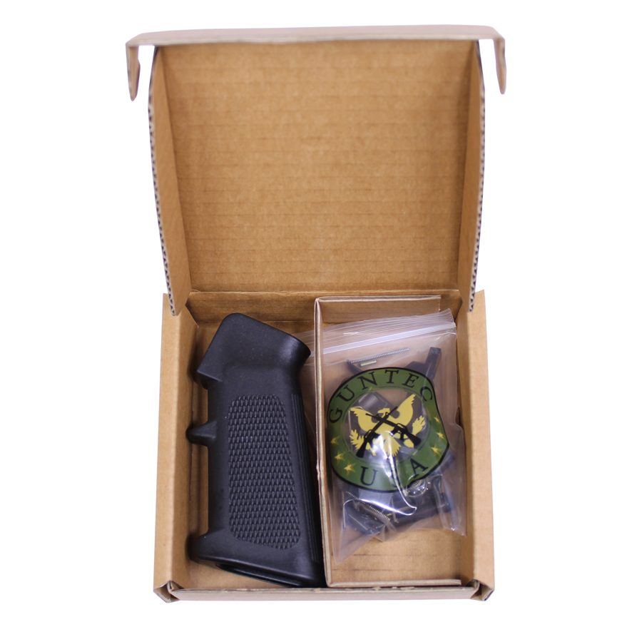 Cardboard box with gun grip and packaged green tactical accessory inside.