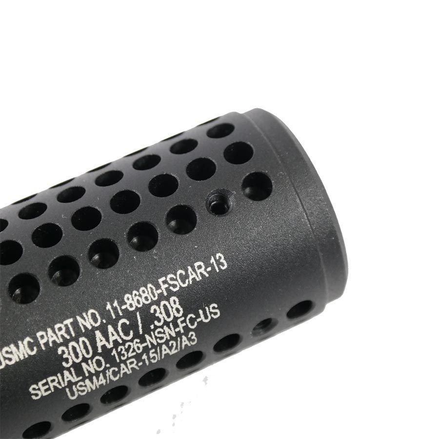 Black perforated firearm muzzle device with engraved markings, heat dissipation, made in USA.