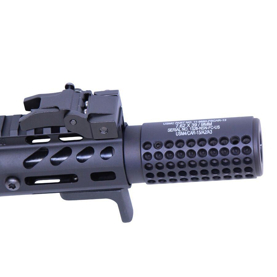 Close-up of KAC muzzle device on tactical firearm showcasing precision design and advanced technology.
