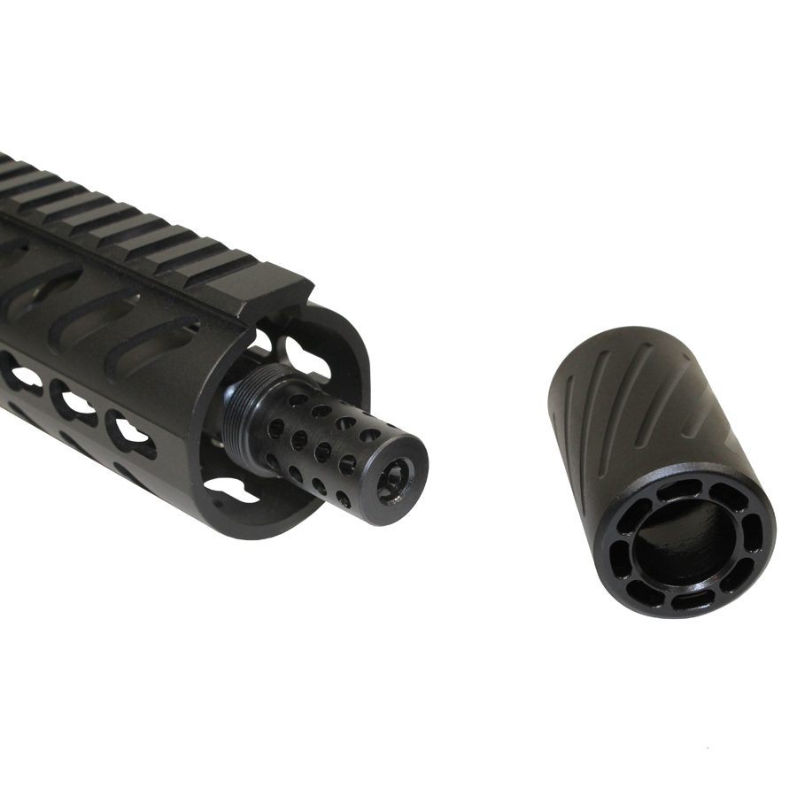 Close-up of tactical rifle barrel and detached muzzle device with precision-machined components.