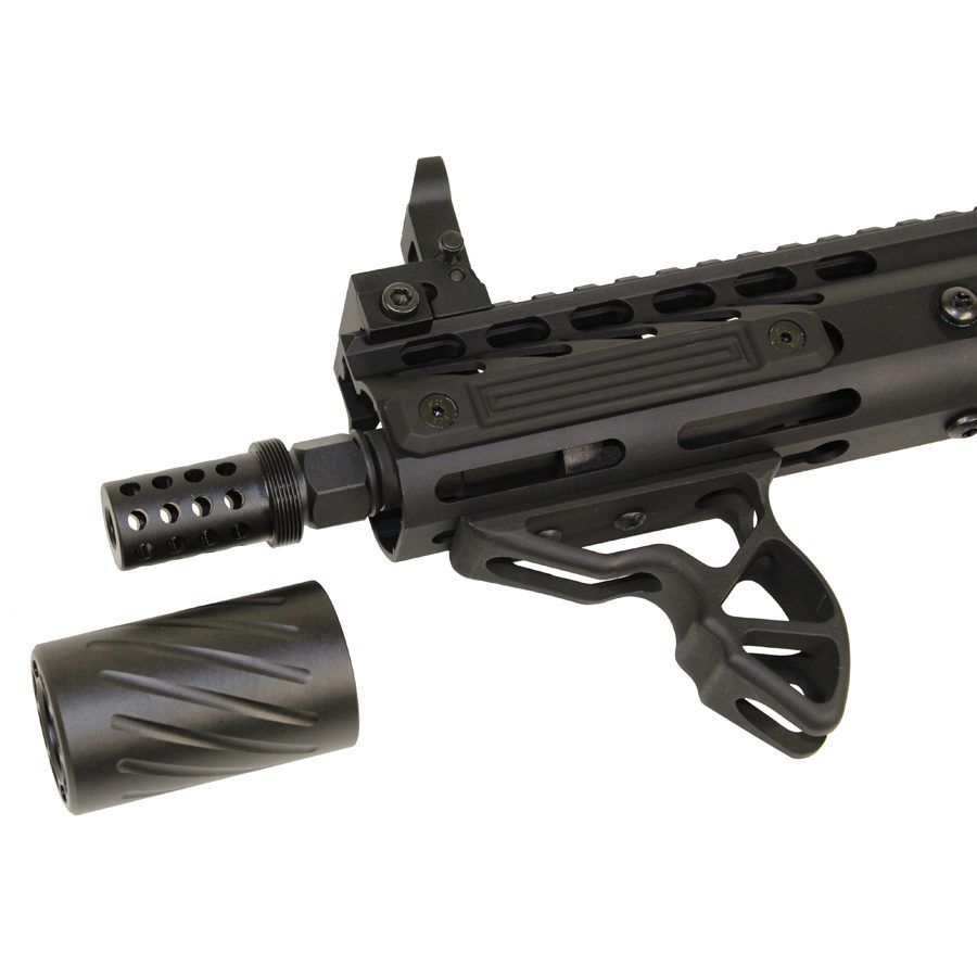 Close-up of tactical firearms muzzle, rail system, and grip; modern design, matte black finish.