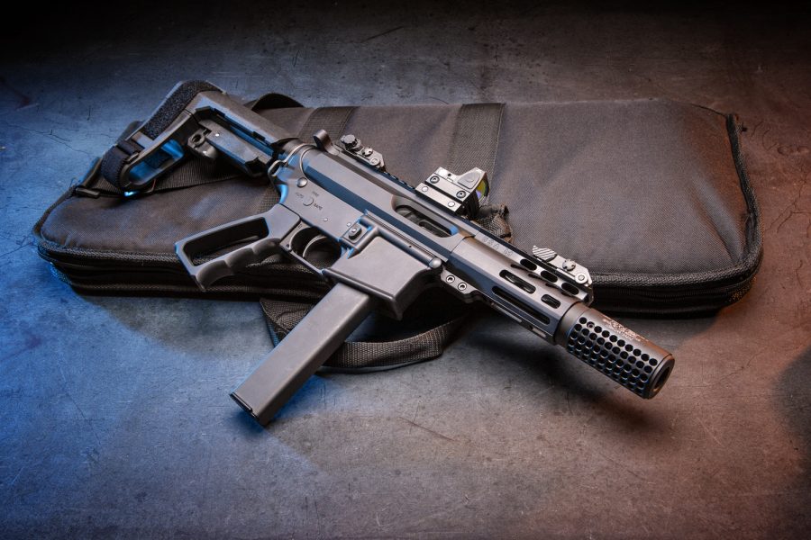 Black submachine gun on tactical case, highlighting its sleek tactical design.
