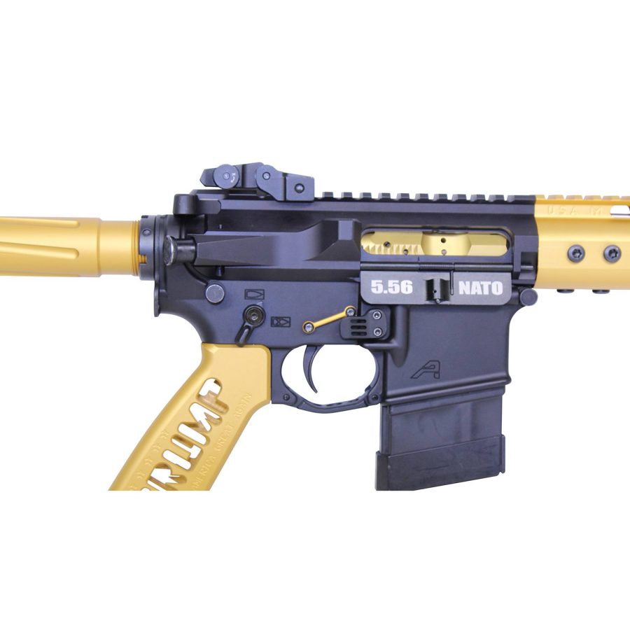 Close-up of a customized black and gold AR-15 rifle receiver with magazine inserted.