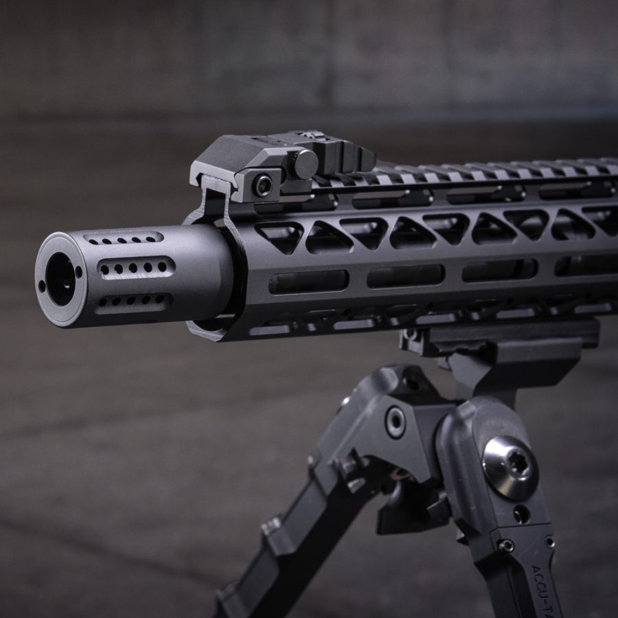 Modern tactical rifle with muzzle brake, skeletonized handguard, and adjustable bipod for precision.