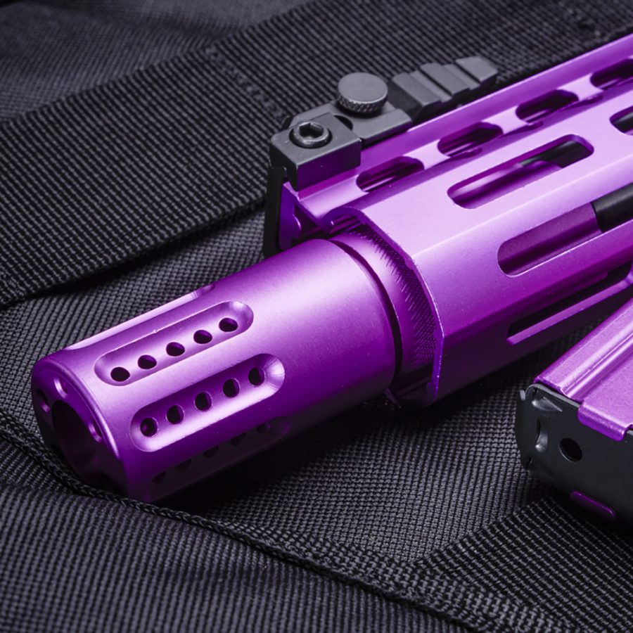 Purple firearm with muzzle brake on black tactical case, showcasing customization and bold design.