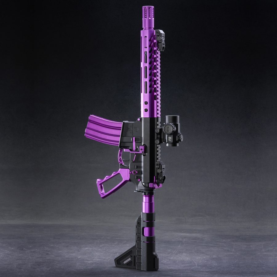 Custom purple and black AR-15 rifle with glossy finish against dark background.