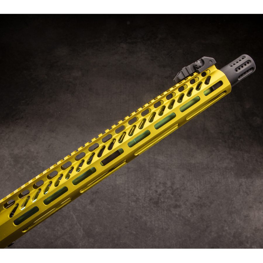 Yellow firearm handguard with perforations, black muzzle device, showcasing modern tactical design.