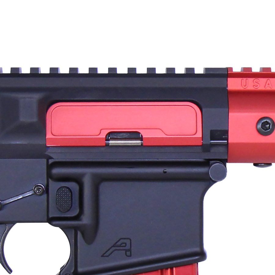 Close-up of black airsoft gun with red accents, focusing on receiver and trigger assembly.