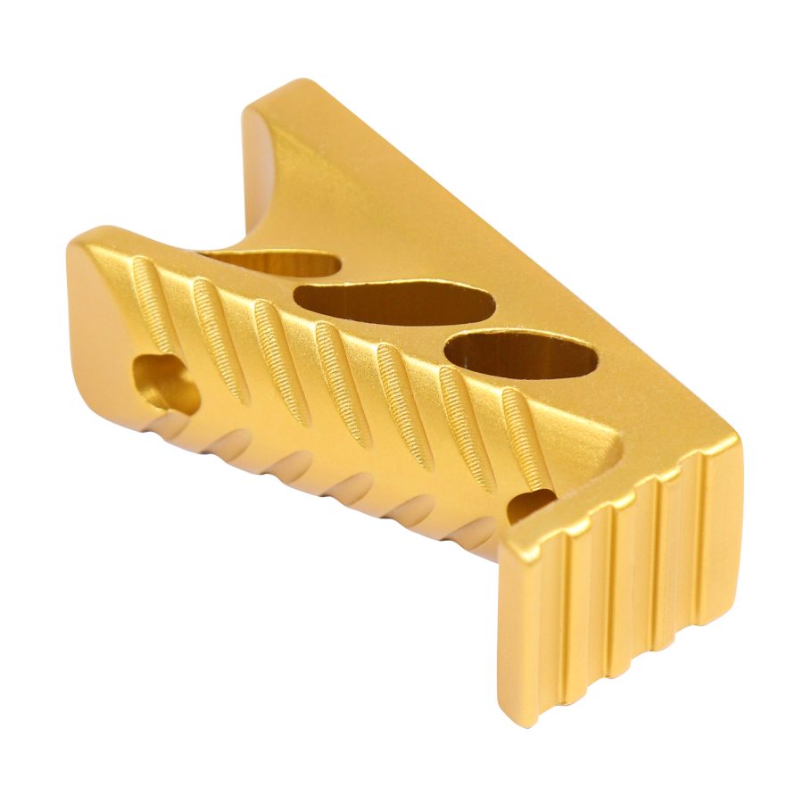 Gold anodized CNC-machined firearm compensator with three gas ports and precise grooves.