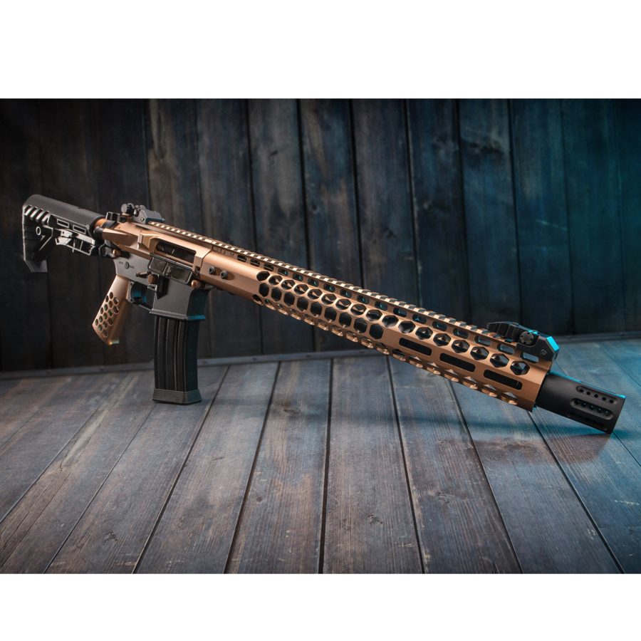 Bronze tactical rifle with suppressor on blue wooden planks, featuring ergonomic adjustable stock.
