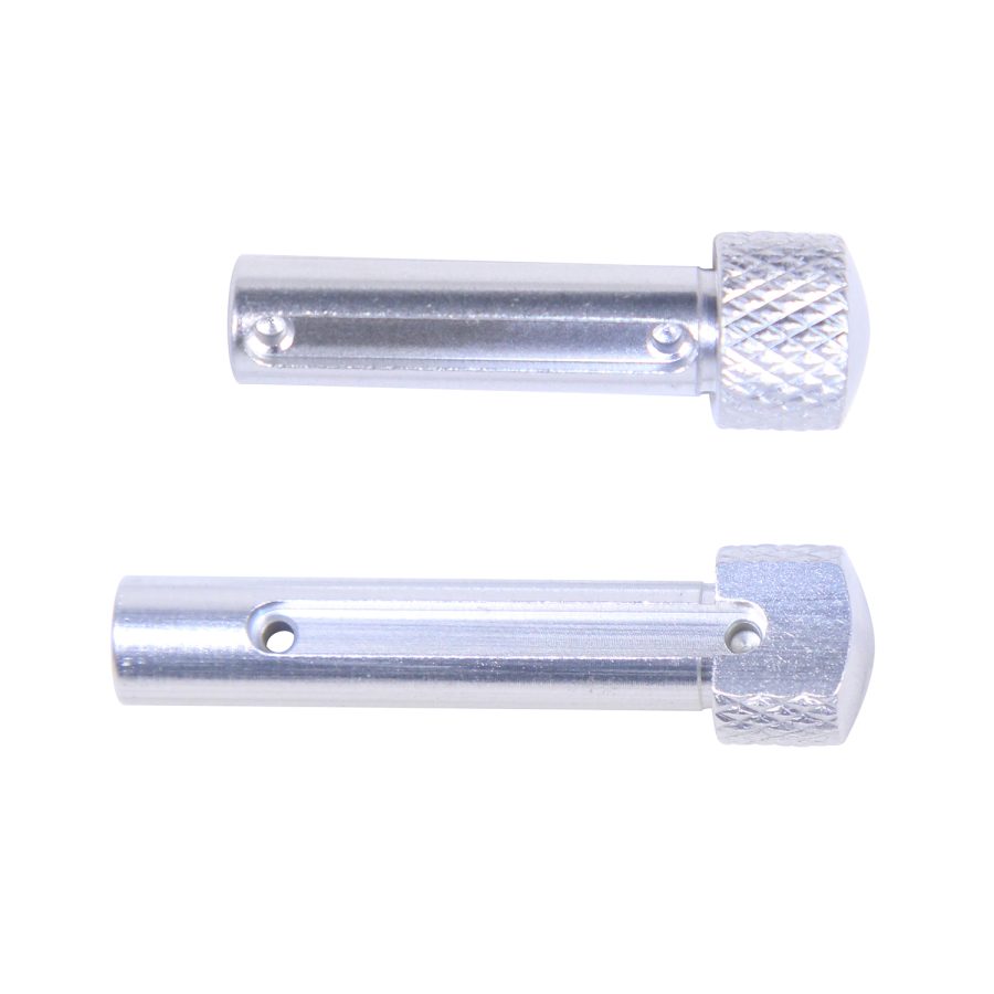Precision-machined connector pins with knurled caps and attachment holes on a white background.