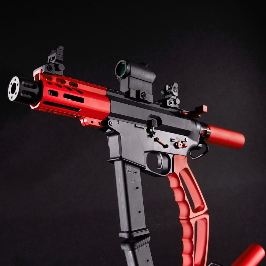 Compact red and black firearm with tactical features and precision design for enthusiasts.