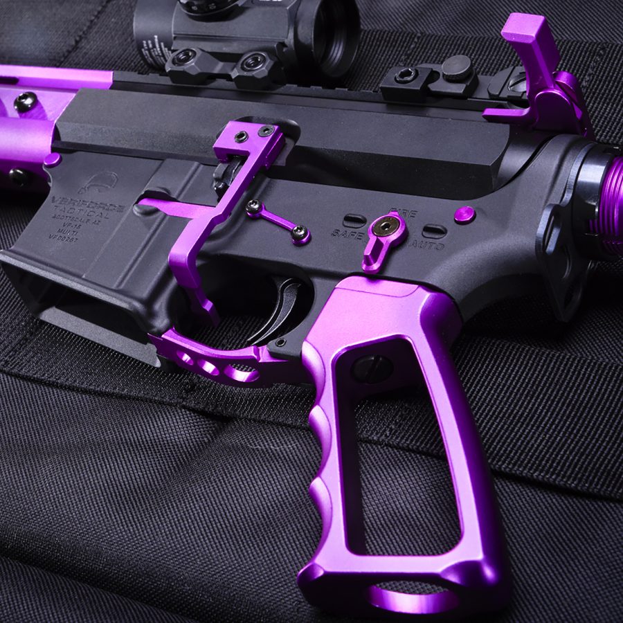 Custom purple accented AR-style rifle on black textile surface.