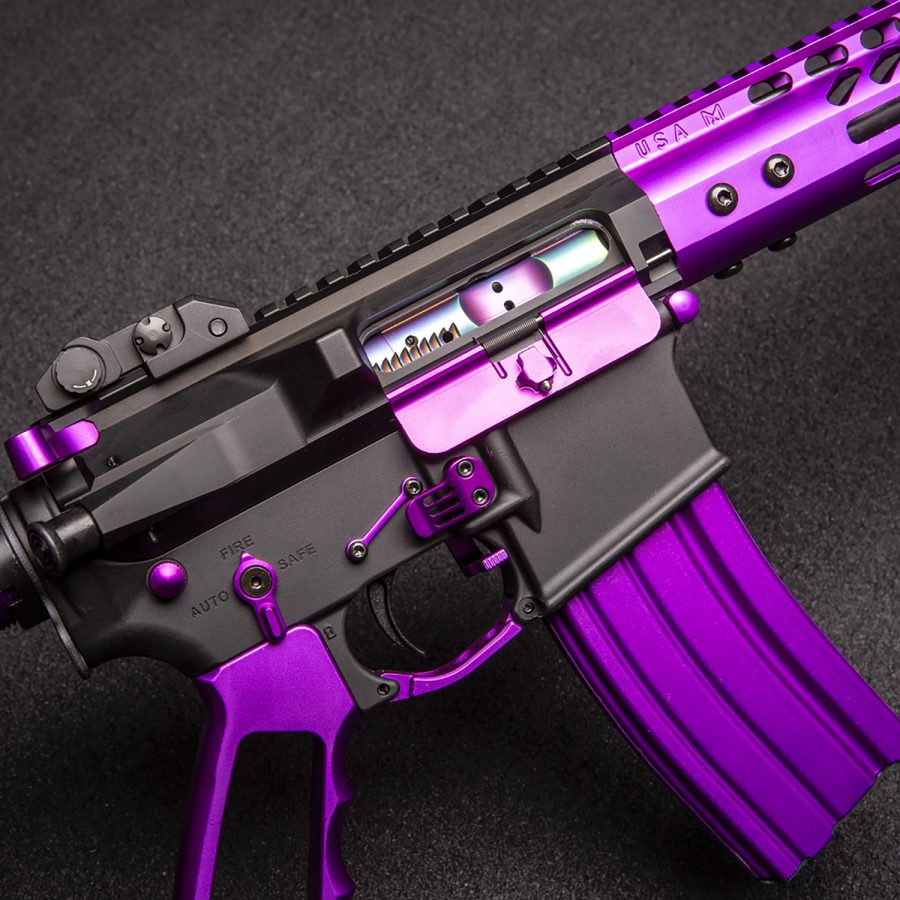 Custom AR rifle with purple accents, black body, USA engraving; distinctive vibrant presentation.