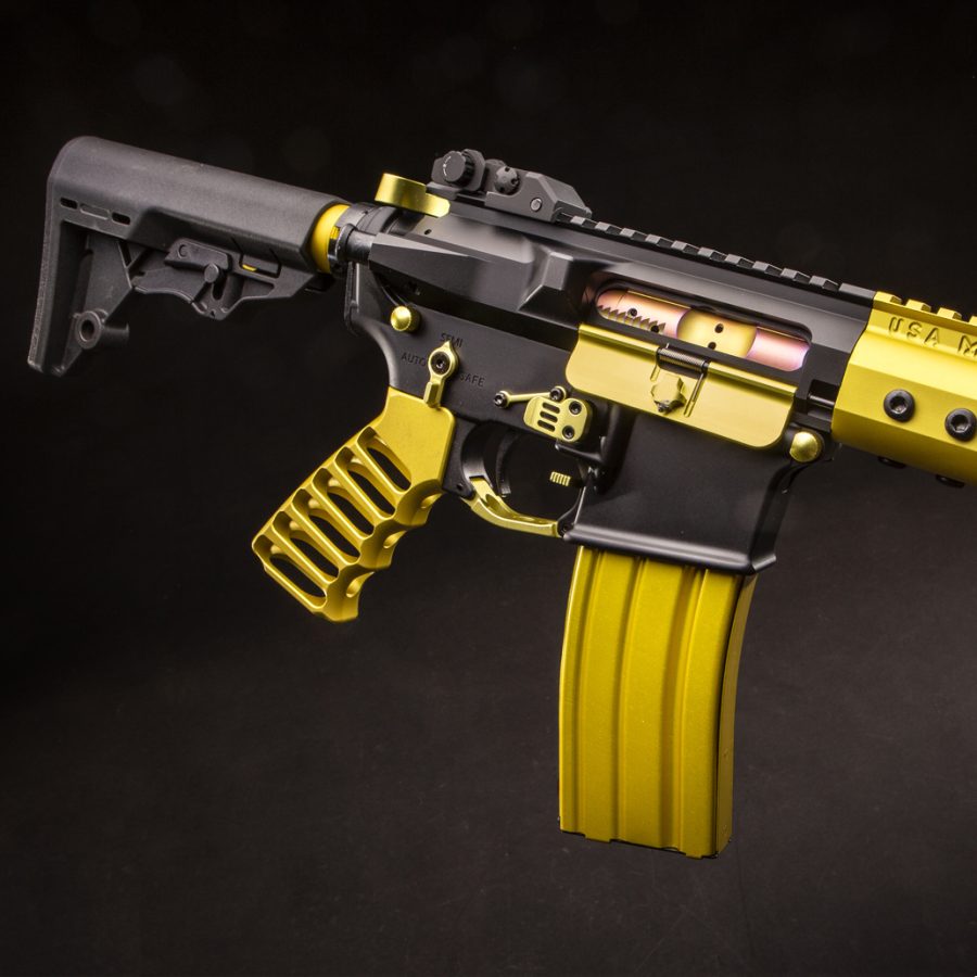 Custom black and yellow AR-style tactical rifle with unique design and striking colors.