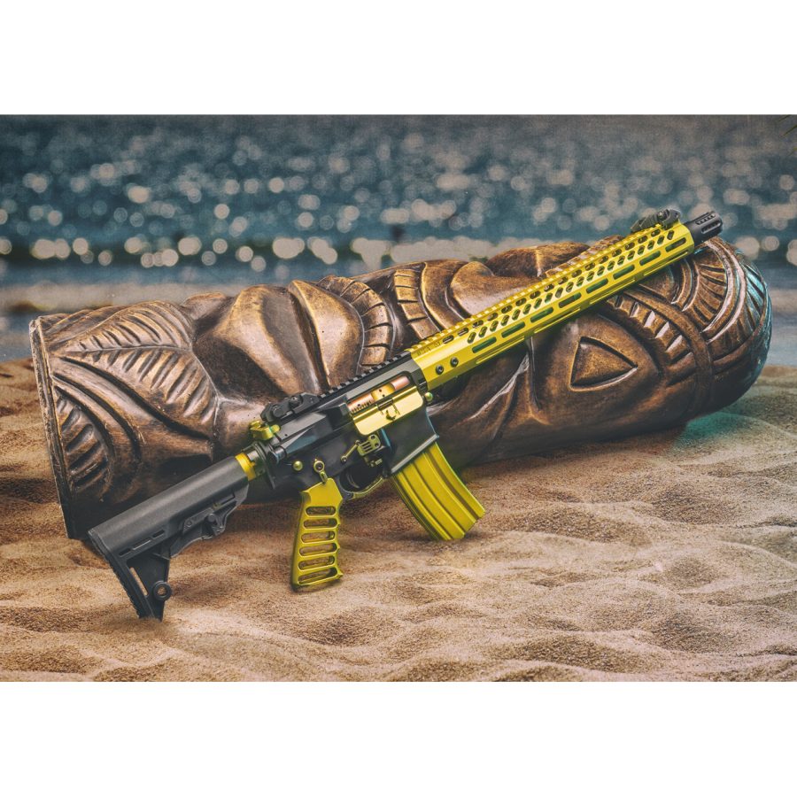 Yellow-accented AR rifle against Polynesian tiki carving on a beach, tradition meets modernity.