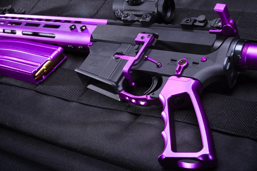 Custom purple AR-15 rifle with anodized finish on magazine, grip, and handguard.