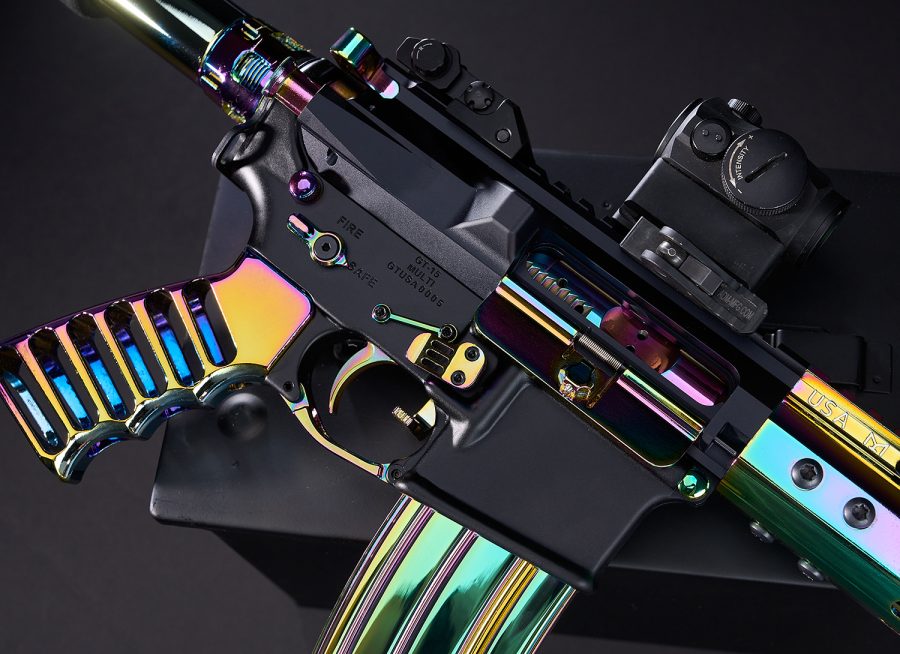 Customized black AR firearm with rainbow PVD coating, optical sight, artistic and functional design.