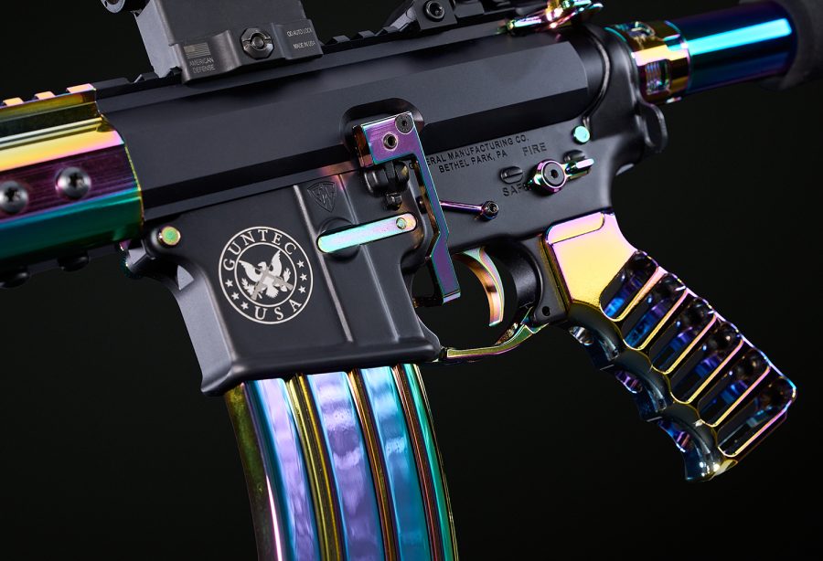 Custom AR-style rifle with matte black body and oil slick iridescent accents.