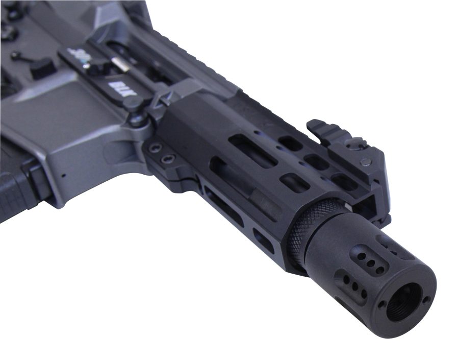Close-up of AR-style rifle barrel and handguard with M-LOK slots and flash hider.