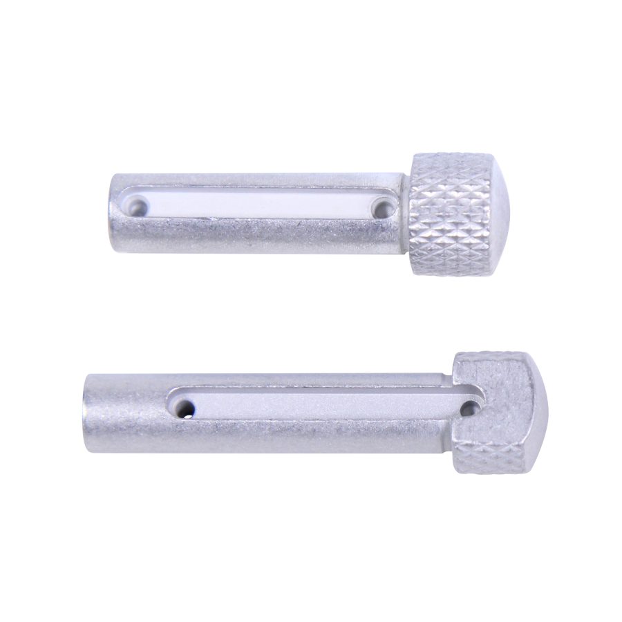 Two metallic clevis pins on white background with textured heads for industrial applications.