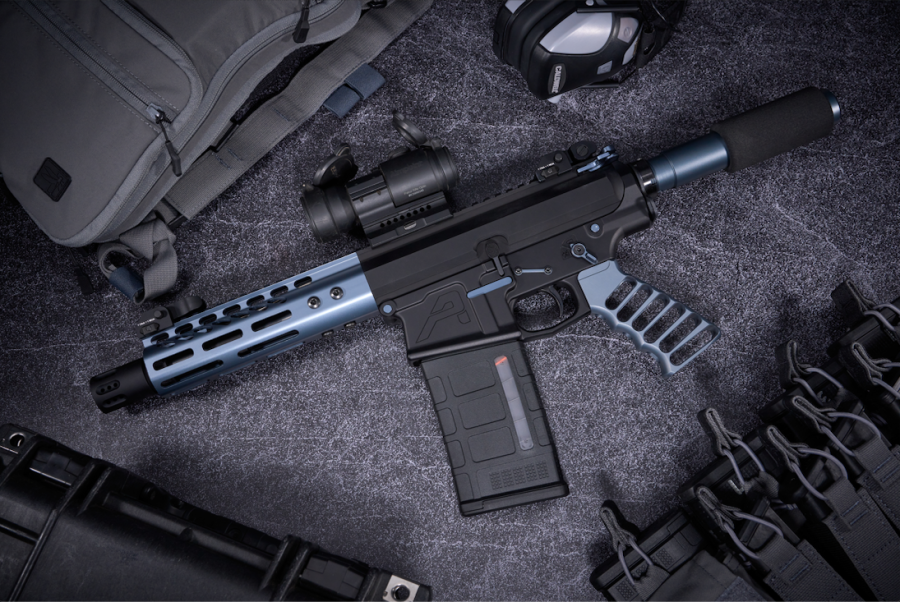 AR-style rifle with tactical gear on display, featuring optics and accessories for enthusiasts.