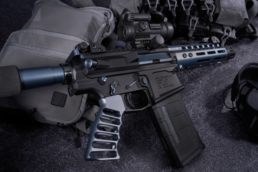 Custom AR-15 with modifications and tactical gear showcased in a high-contrast professional photo.