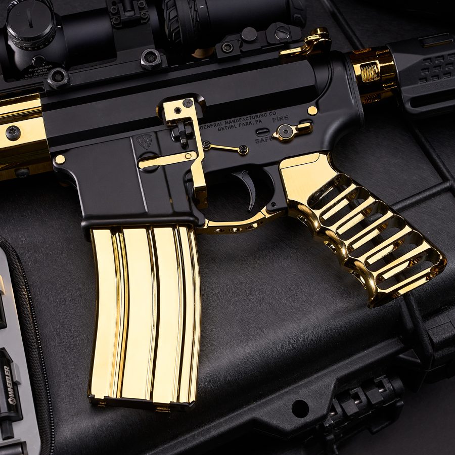Luxury black-and-gold AR rifle, premium craftsmanship, gold-plated parts, tactical setup display.