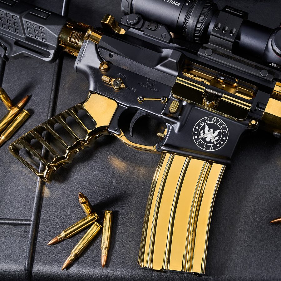 Luxurious black and gold AR-style rifle with scope, GUNTEC USA logo, and gold components.