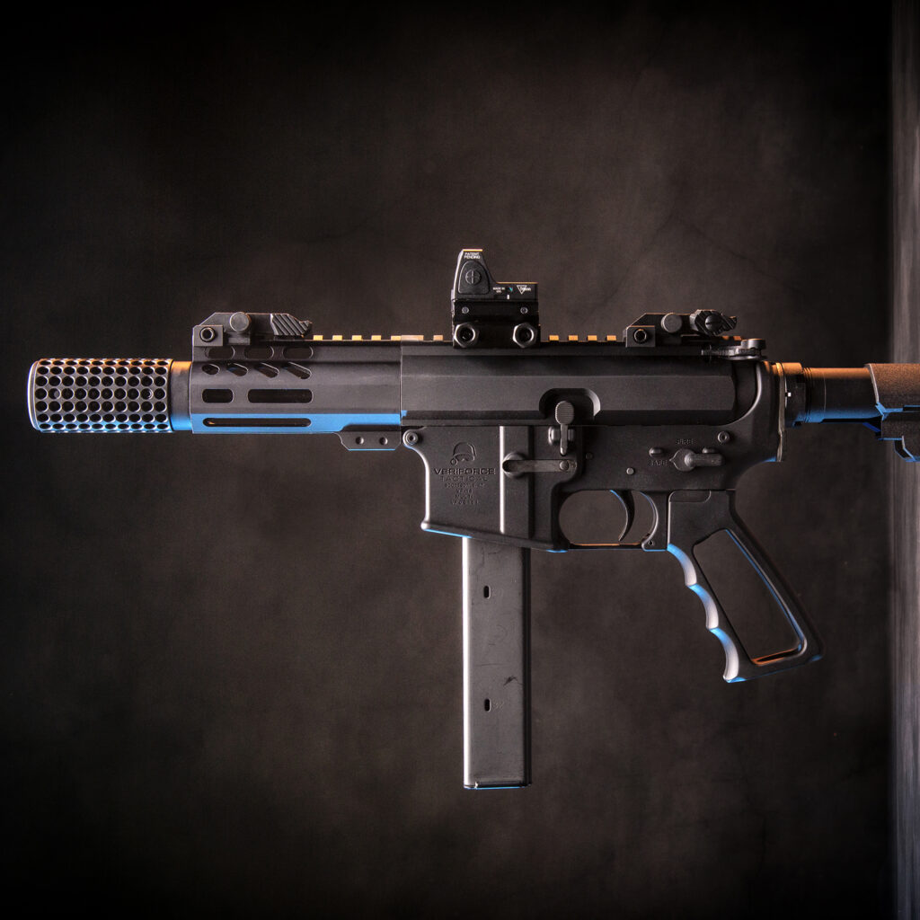 Custom submachine gun with black and blue accents, featuring optic sight and extended magazine.