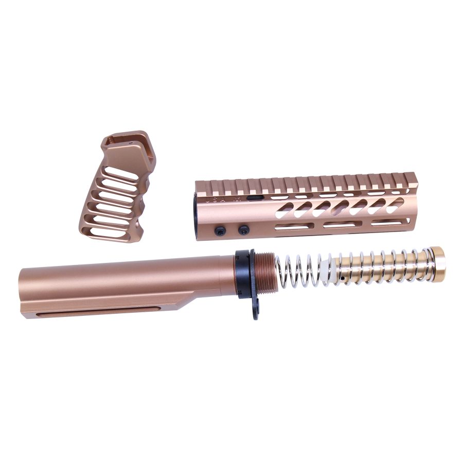 Rose gold AR-15 components: pistol grip, handguard, buffer tube with recoil spring on white background.