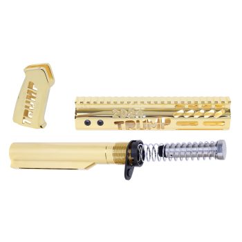 Gold-plated AR rifle parts engraved with TRUMP 2024 on a white background.