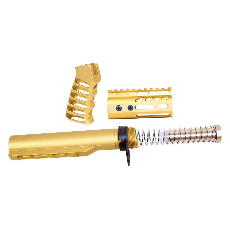 Gold-anodized AR-15 parts: buffer tube, pistol grip, and rail system on white background.